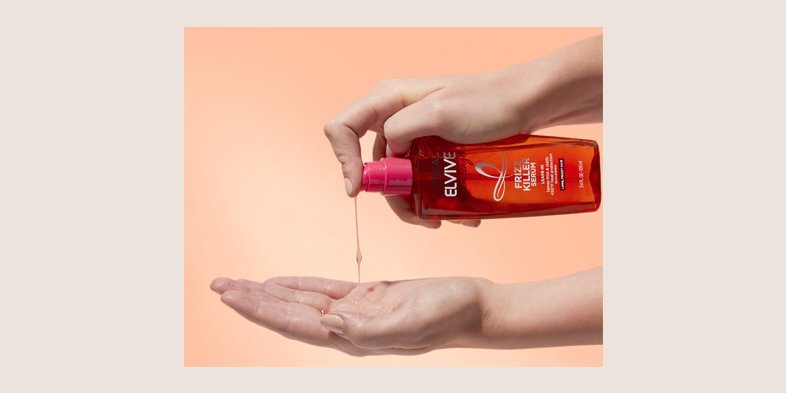 Someone squirting conditioner in their hand